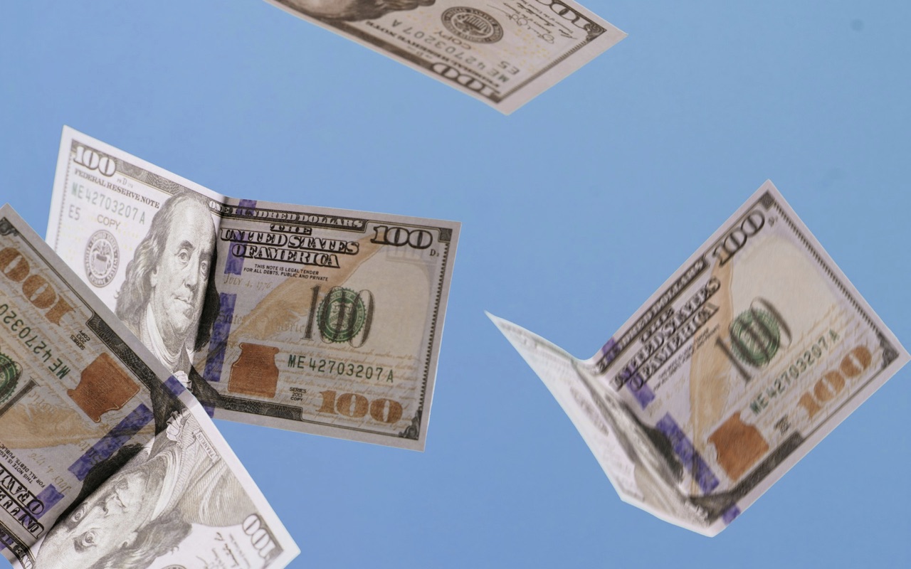 Dollar notes thrown in air