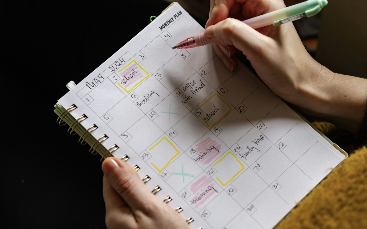 A woman writing on her daily planner