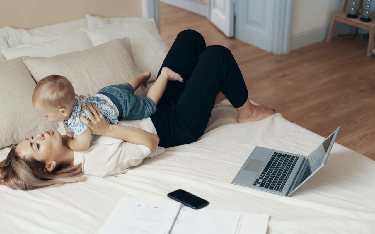 A mom working from home, playing with her baby